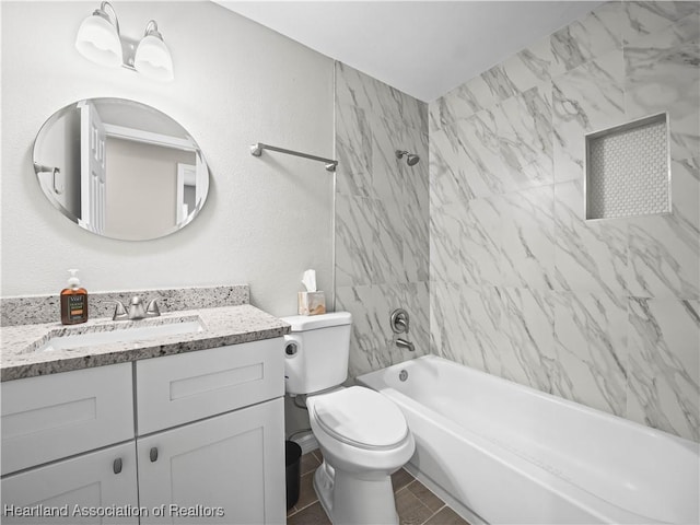 full bathroom featuring vanity, toilet, and tiled shower / bath combo