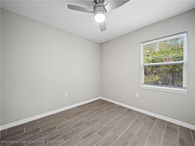 spare room featuring hardwood / wood-style flooring and ceiling fan