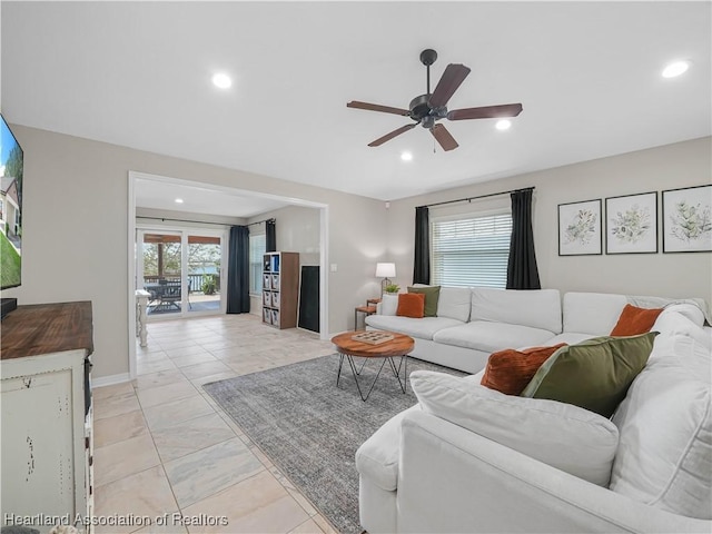 living room with a ceiling fan, recessed lighting, and baseboards