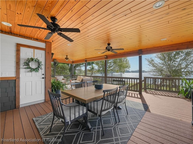 wooden terrace featuring ceiling fan and outdoor dining space