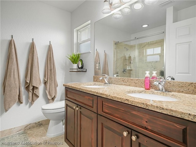 bathroom featuring vanity, toilet, and a shower with shower door