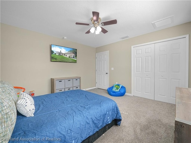 carpeted bedroom featuring visible vents, a closet, baseboards, and a ceiling fan