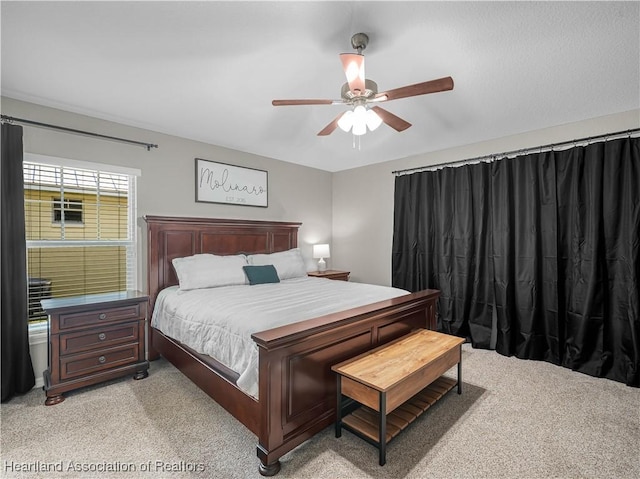 bedroom featuring a ceiling fan and light colored carpet