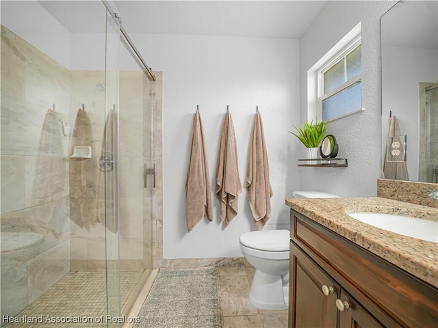 bathroom with vanity, toilet, and walk in shower