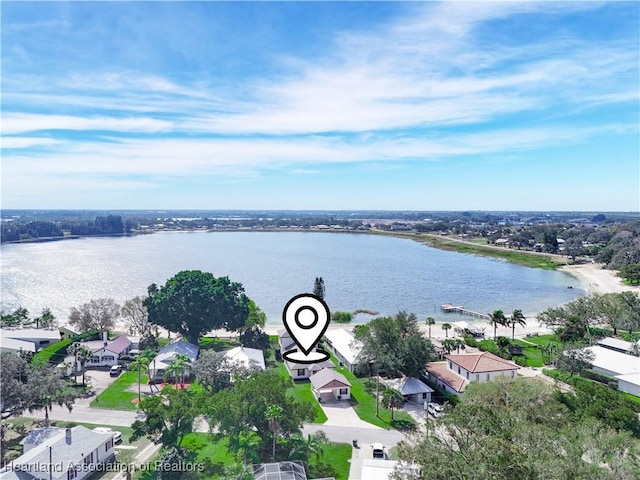 birds eye view of property with a water view and a residential view