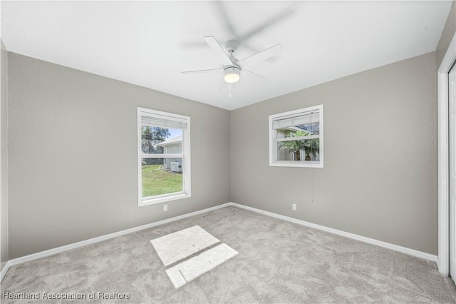 spare room with light colored carpet and ceiling fan