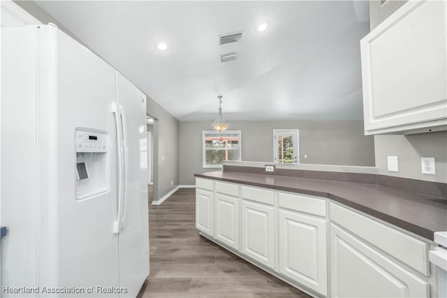 kitchen with white cabinetry, light hardwood / wood-style floors, and white refrigerator with ice dispenser