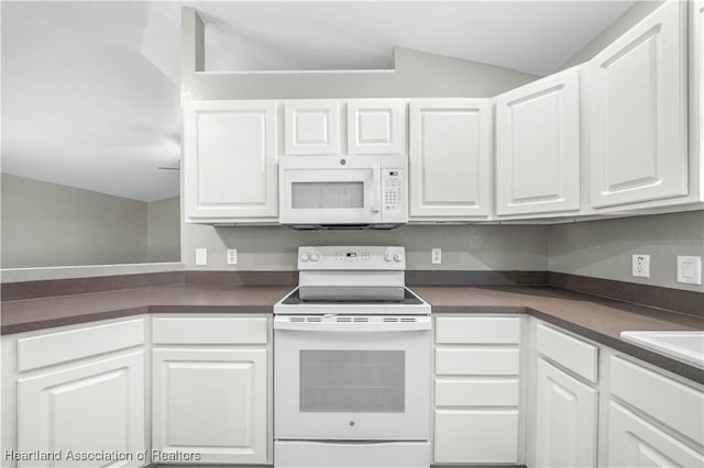 kitchen with vaulted ceiling, white cabinetry, and white appliances