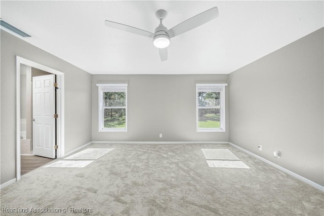 spare room featuring ceiling fan and carpet floors