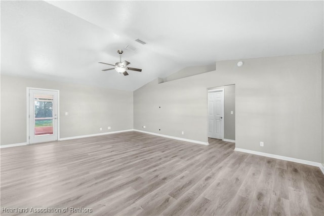 spare room with ceiling fan, light hardwood / wood-style floors, and vaulted ceiling