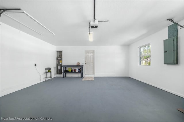 garage featuring a garage door opener, electric panel, and water heater