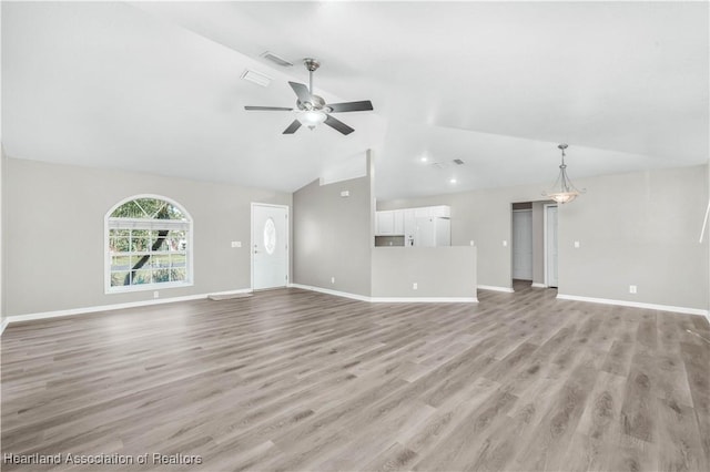 unfurnished living room featuring ceiling fan, light hardwood / wood-style flooring, and vaulted ceiling