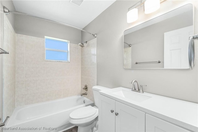 full bathroom featuring vanity, toilet, and tiled shower / bath combo