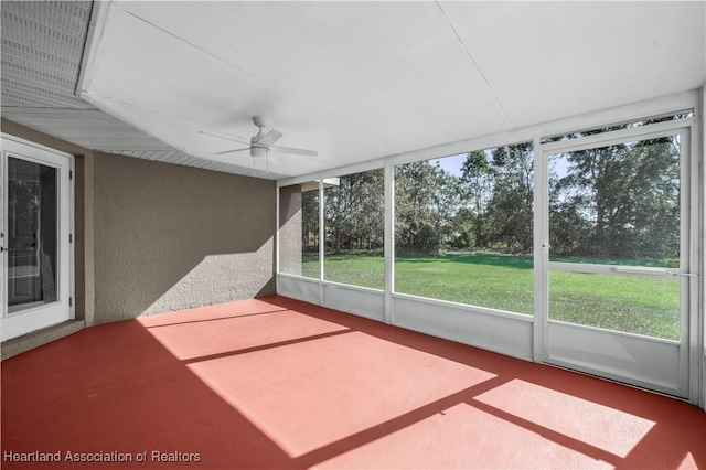 unfurnished sunroom featuring ceiling fan