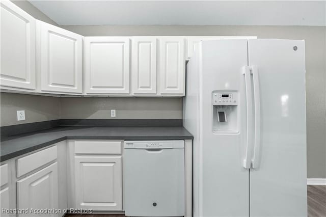 kitchen featuring white cabinetry, hardwood / wood-style floors, and white appliances