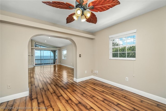 spare room featuring hardwood / wood-style floors, ceiling fan, and vaulted ceiling