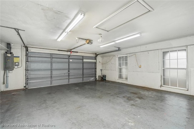 garage featuring electric panel and a garage door opener