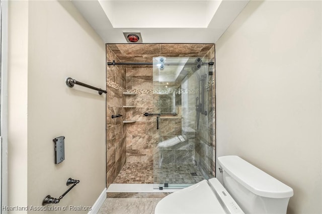 bathroom featuring tile patterned floors, toilet, and walk in shower