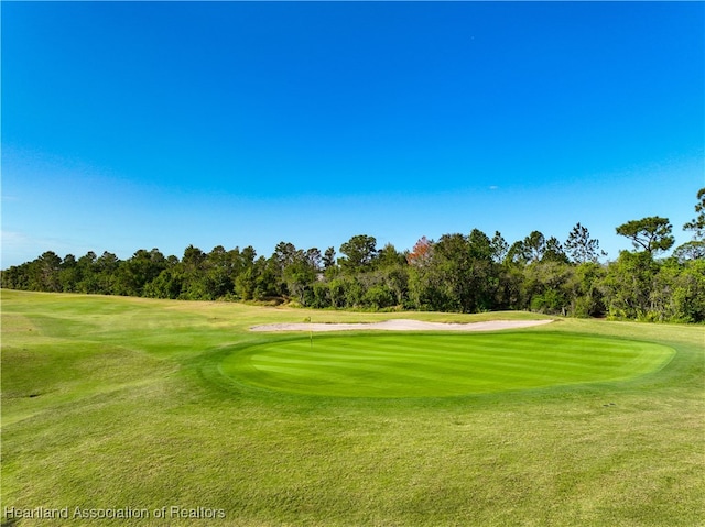 4737 Myrtle Dr, Sebring, FL 33872 - view of property's community featuring view of golf course, a yard, and view of scattered trees