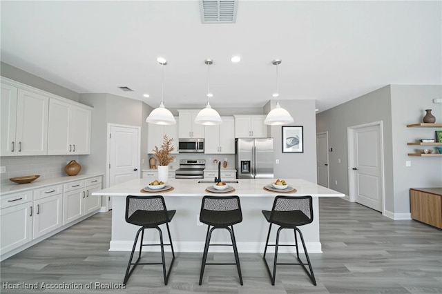 4737 Myrtle Dr, Sebring, FL 33872 - kitchen with appliances with stainless steel finishes, light wood-type flooring, light countertops, and recessed lighting