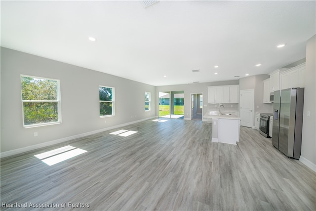 4737 Myrtle Dr, Sebring, FL 33872 - unfurnished living room featuring light wood-type flooring and recessed lighting