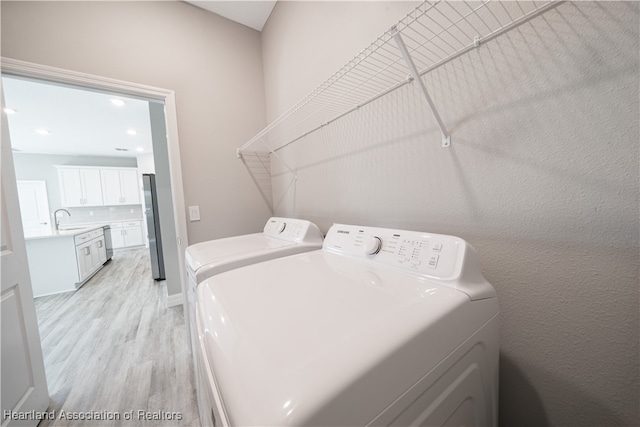 4737 Myrtle Dr, Sebring, FL 33872 - washroom featuring light wood-style floors, washer and clothes dryer, and recessed lighting