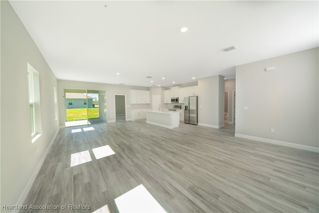 4737 Myrtle Dr, Sebring, FL 33872 - unfurnished living room with light wood finished floors and recessed lighting
