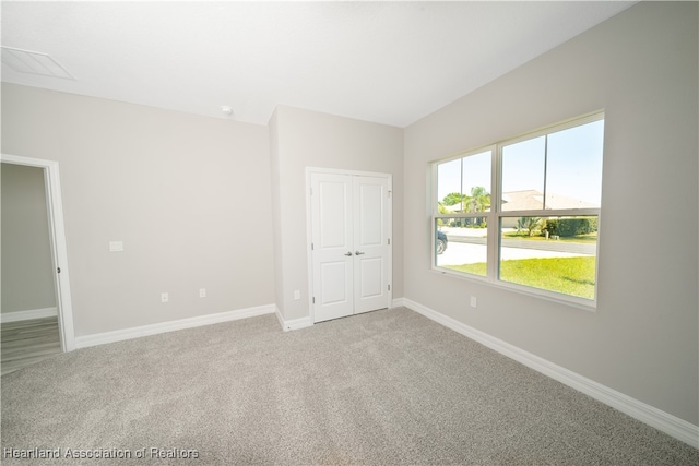 4737 Myrtle Dr, Sebring, FL 33872 - unfurnished bedroom featuring light carpet and a closet
