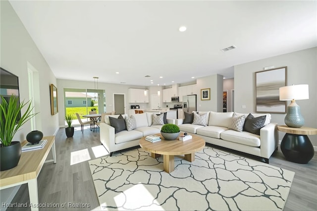 4737 Myrtle Dr, Sebring, FL 33872 - living room with light wood-style flooring and recessed lighting