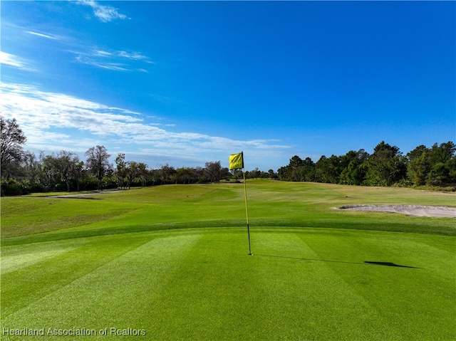 4737 Myrtle Dr, Sebring, FL 33872 - view of home's community featuring golf course view, view of wooded area, and a lawn