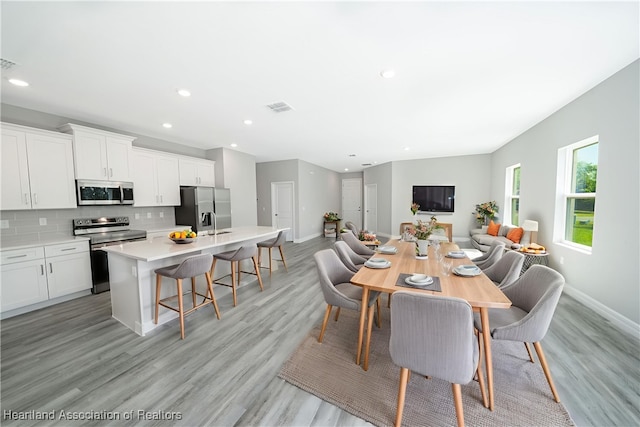 4737 Myrtle Dr, Sebring, FL 33872 - dining space with light wood finished floors and recessed lighting
