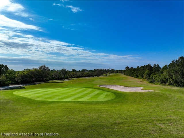 4737 Myrtle Dr, Sebring, FL 33872 - surrounding community with golf course view, a yard, and view of wooded area