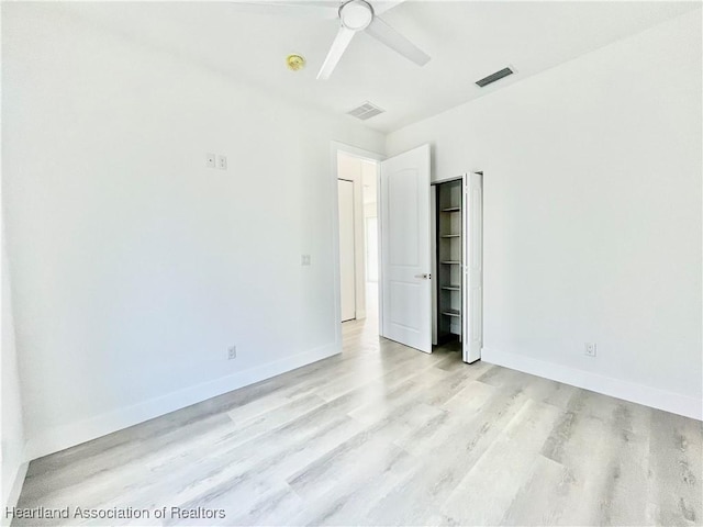 unfurnished bedroom featuring light wood-type flooring and ceiling fan