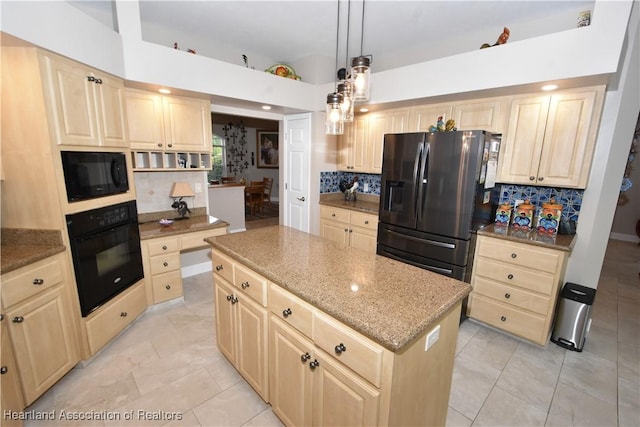 kitchen with a center island, decorative light fixtures, tasteful backsplash, and black appliances