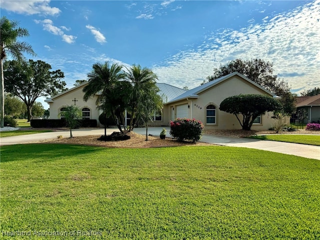 ranch-style home featuring a front yard and a garage