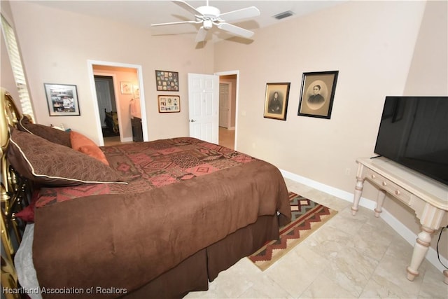 bedroom with ensuite bath and ceiling fan