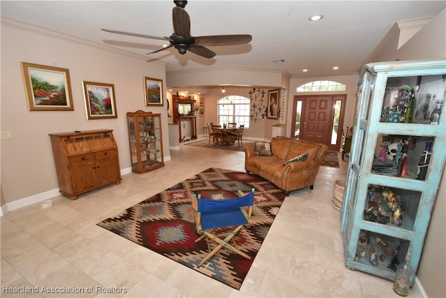 living room with ceiling fan and ornamental molding