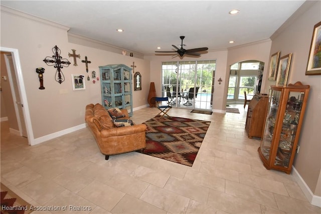 living room featuring ceiling fan and ornamental molding