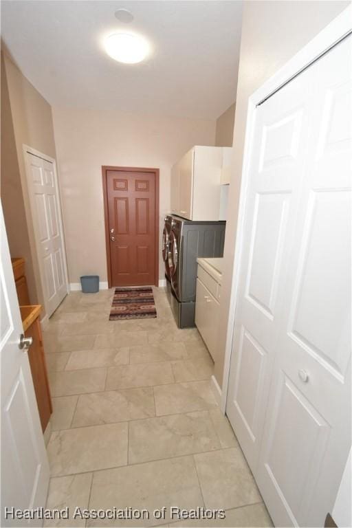 clothes washing area featuring cabinets and independent washer and dryer