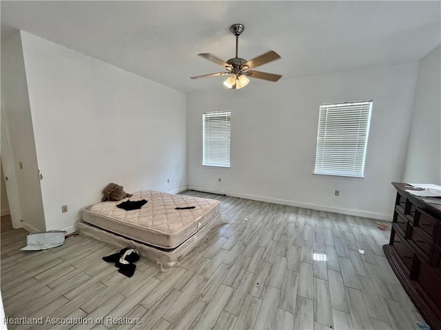 unfurnished bedroom featuring ceiling fan and light wood-type flooring