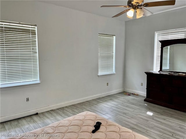 unfurnished bedroom with light hardwood / wood-style floors and ceiling fan