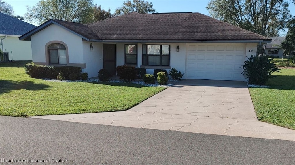 ranch-style home featuring a front yard and a garage