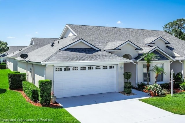 2033 Ashley Oaks Cir, Sebring, FL 33870 - view of front of home with a shingled roof, stucco siding, driveway, and a garage