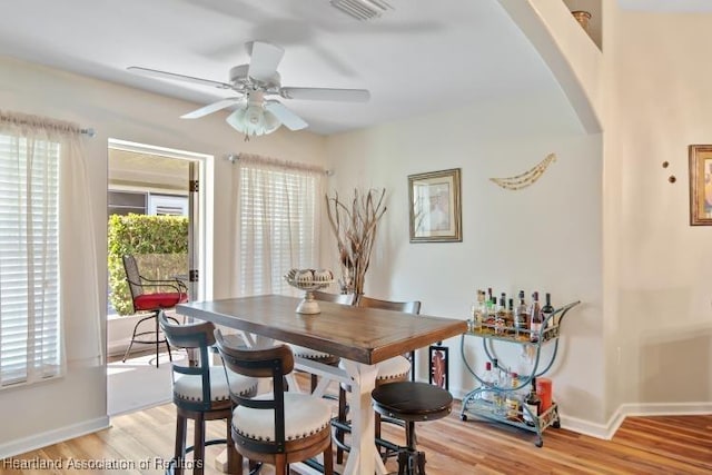 2033 Ashley Oaks Cir, Sebring, FL 33870 - dining area featuring light wood-style flooring, baseboards, visible vents, ceiling fan, and arched walkways