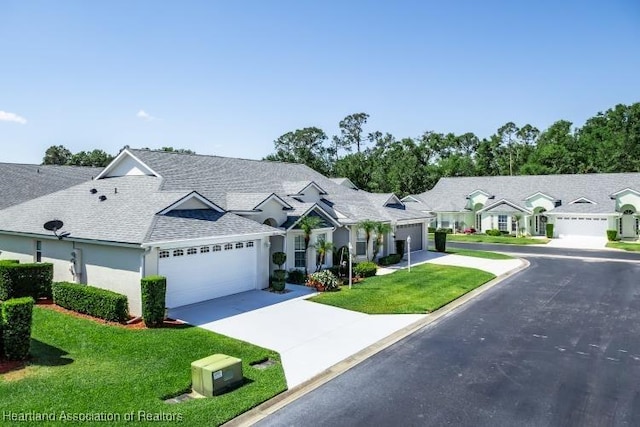 2033 Ashley Oaks Cir, Sebring, FL 33870 - view of front of house featuring roof with shingles, an attached garage, a residential view, driveway, and a front yard
