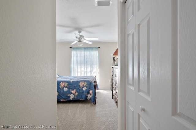 2033 Ashley Oaks Cir, Sebring, FL 33870 - bedroom featuring a textured wall, carpet flooring, ceiling fan, and visible vents