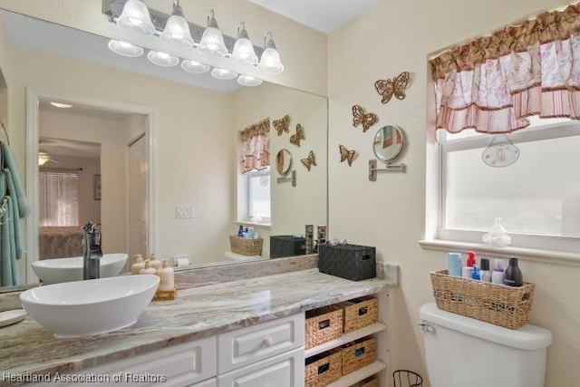 2033 Ashley Oaks Cir, Sebring, FL 33870 - bathroom featuring toilet, vanity, and a ceiling fan