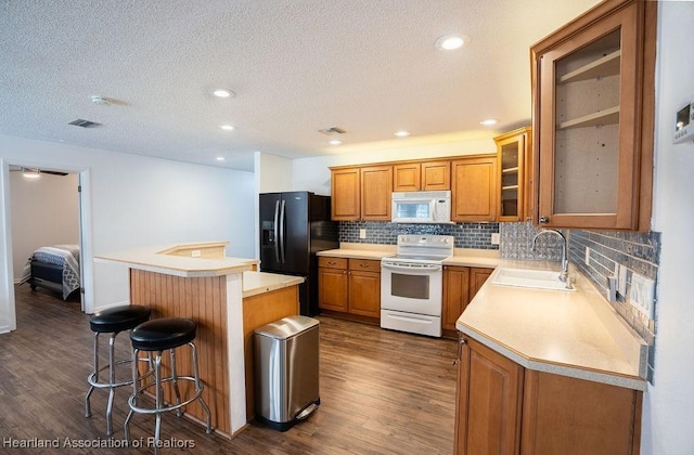 kitchen featuring electric range oven, black fridge with ice dispenser, dark wood-type flooring, sink, and a kitchen island