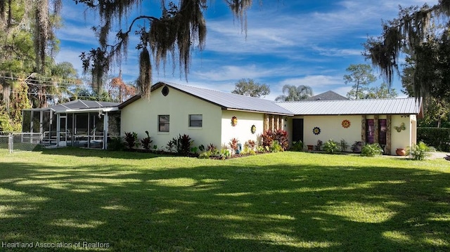 single story home featuring a lanai and a front lawn