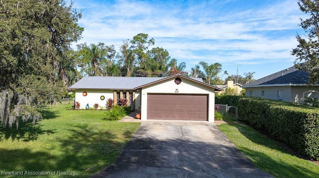 single story home featuring a front lawn and a garage